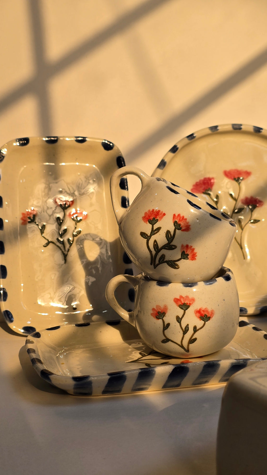Decorative ceramic items with floral designs on a white background