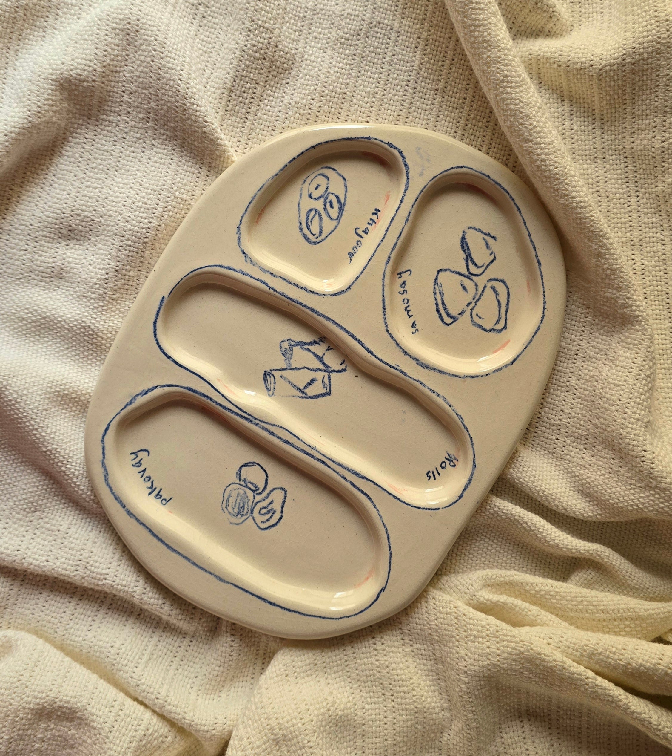 A beige ceramic iftar tray with fun illustrations of food best for gifting pinterest style handmade in pakistan by pastel jade ceramic studio