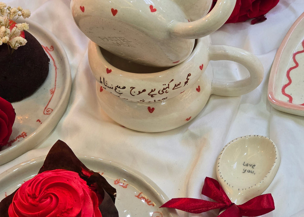 handmade and handpainted ceramic mug with urdu song and poetry perfect for gifting on valentines day and other occasions made by pastel jade ceramic studio in pakistan it is oven safe and foodgrade fired at high temperature in gas furnace made with stoneware clay and leadfree glaze 