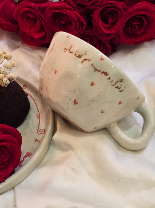 handmade and handpainted ceramic mug with urdu song and poetry perfect for gifting on valentines day and other occasions made by pastel jade ceramic studio in pakistan it is oven safe and foodgrade fired at high temperature in gas furnace made with stoneware clay and leadfree glaze 