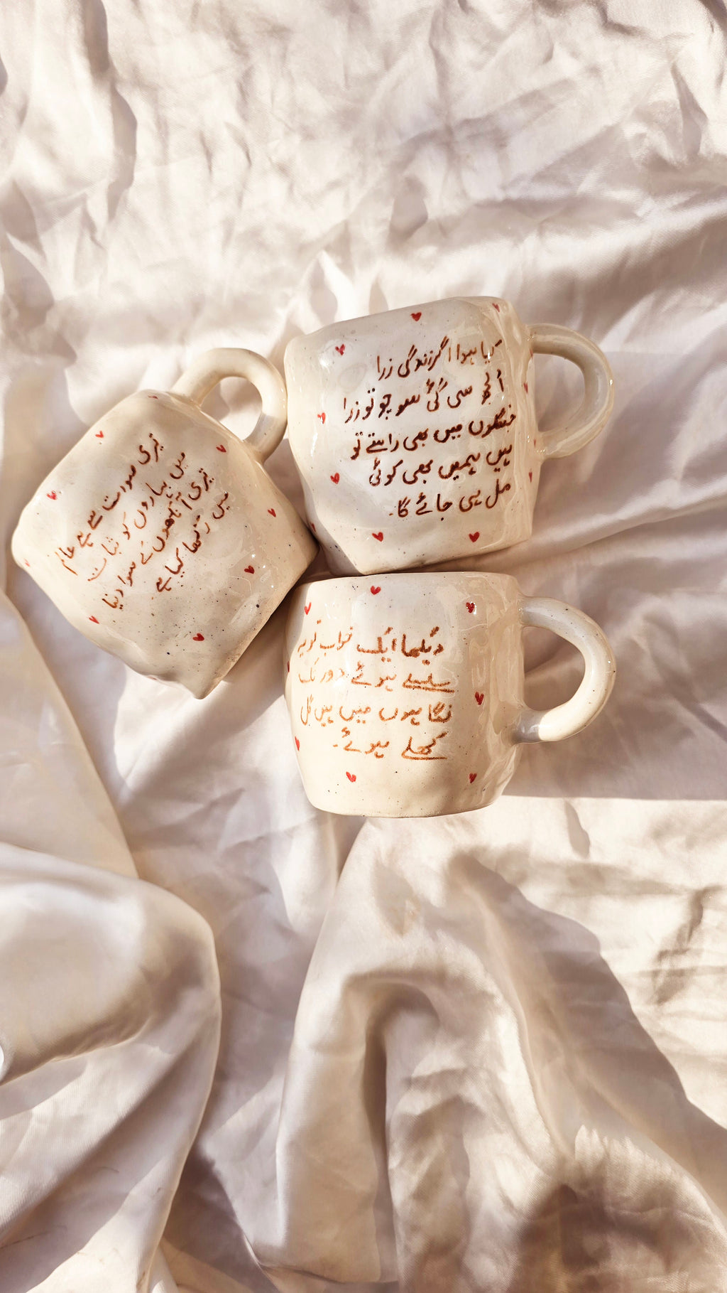 handmade and handpainted ceramic mug with urdu song and poetry perfect for gifting on valentines day and other occasions made by pastel jade ceramic studio in pakistan it is oven safe and foodgrade fired at high temperature in gas furnace made with stoneware clay and leadfree glaze 
